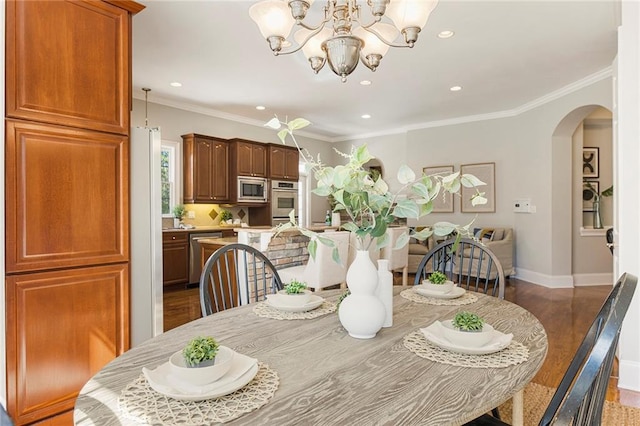 dining space with light hardwood / wood-style flooring, crown molding, and a chandelier