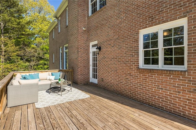 wooden terrace with an outdoor living space