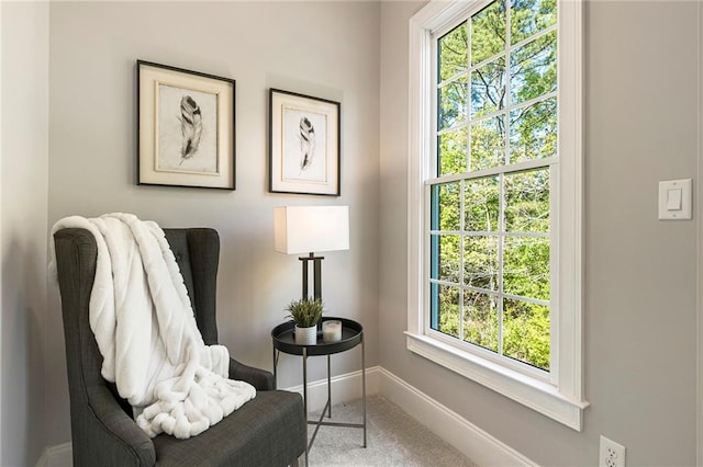 sitting room featuring a healthy amount of sunlight and light colored carpet