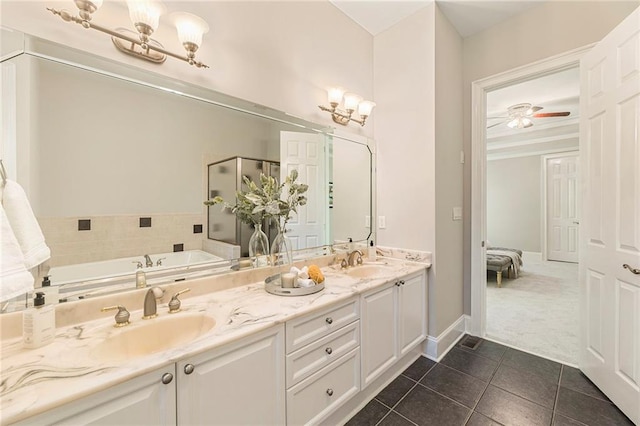 bathroom featuring oversized vanity, a washtub, double sink, ceiling fan with notable chandelier, and tile floors