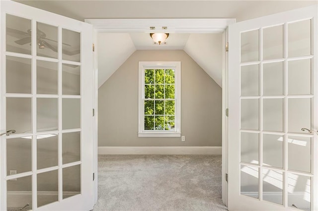 bonus room featuring lofted ceiling, ceiling fan, and light carpet