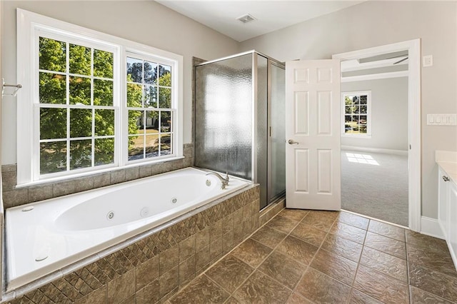 bathroom featuring shower with separate bathtub, tile floors, and vanity