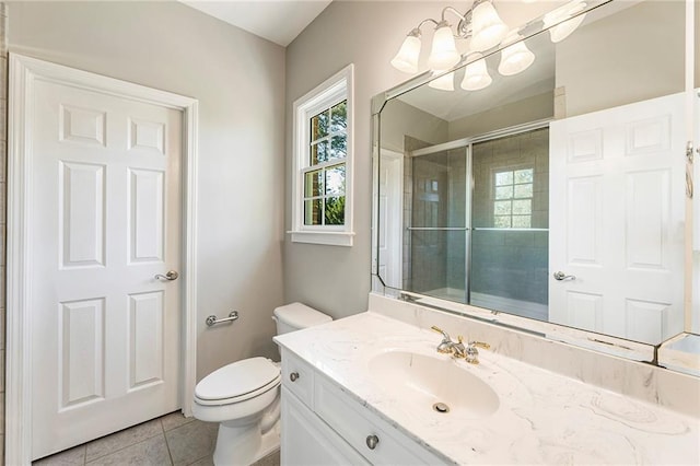 bathroom featuring a notable chandelier, tile floors, oversized vanity, and toilet