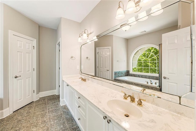 bathroom featuring dual sinks, tile flooring, large vanity, and a tub