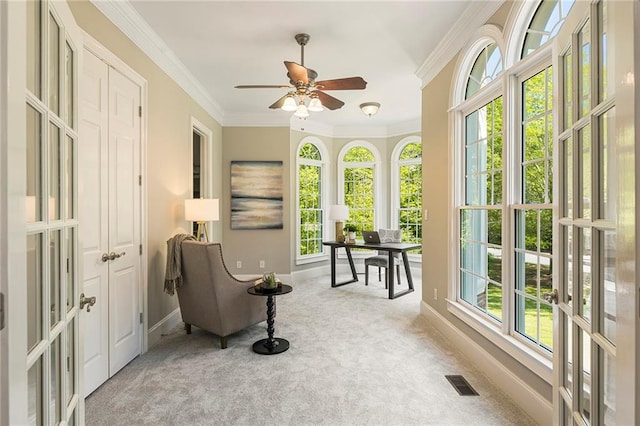 sunroom featuring ceiling fan and a wealth of natural light