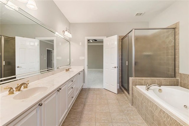 bathroom with double sink vanity, tile flooring, and shower with separate bathtub