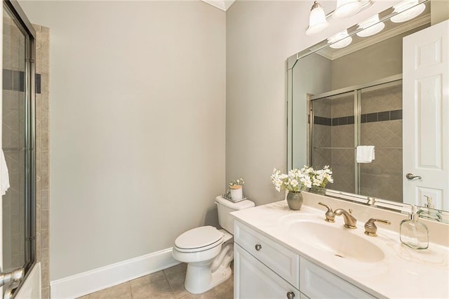 bathroom featuring tile flooring, ornamental molding, toilet, and vanity