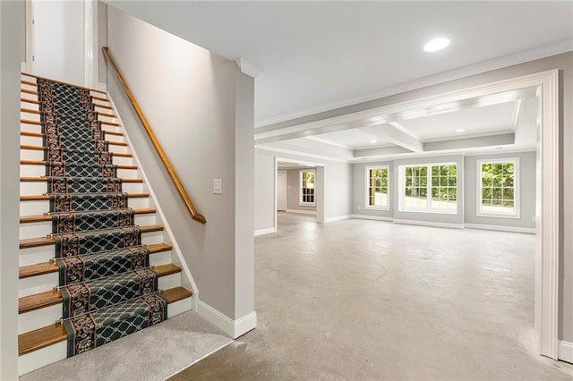 stairway featuring a tray ceiling and ornamental molding