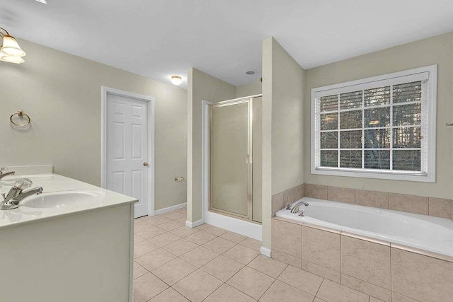 bathroom featuring tile patterned flooring, vanity, and shower with separate bathtub