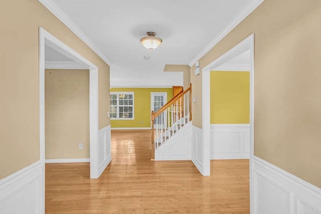 foyer featuring light wood-type flooring and ornamental molding