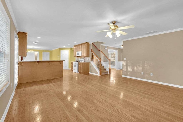 unfurnished living room with ceiling fan, light hardwood / wood-style floors, and ornamental molding