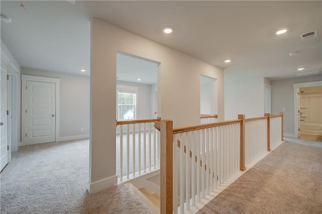 corridor with light colored carpet