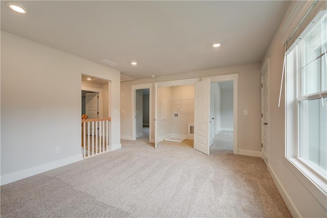 unfurnished bedroom featuring light carpet