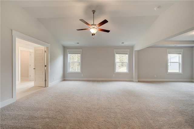 carpeted empty room featuring plenty of natural light, lofted ceiling, and ceiling fan