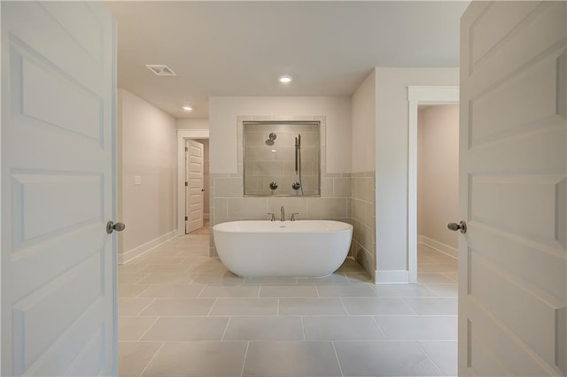 bathroom with tile patterned flooring and independent shower and bath