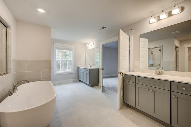 bathroom featuring vanity and shower with separate bathtub