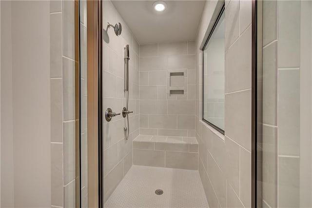 bathroom featuring a shower with door