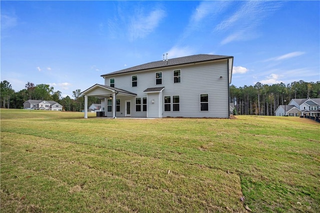 rear view of property with a lawn