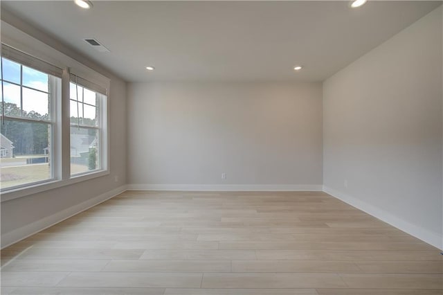 spare room with light hardwood / wood-style flooring