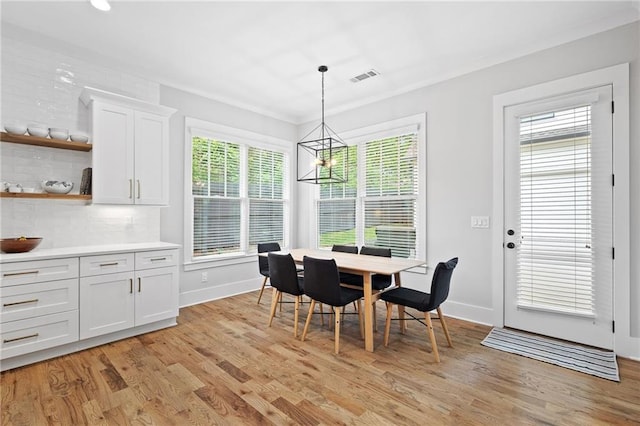 313 Sisson Ave NE, Atlanta, GA 30317 - dining room with light wood-type flooring, baseboards, and a chandelier