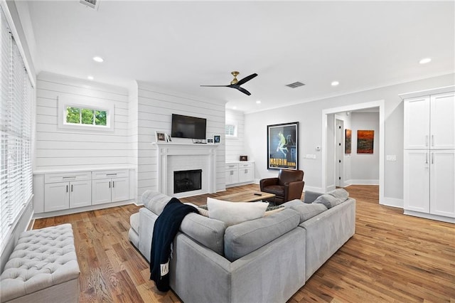 313 Sisson Ave NE, Atlanta, GA 30317 - living area featuring ceiling fan, a fireplace, light wood-style floors, recessed lighting, and crown molding