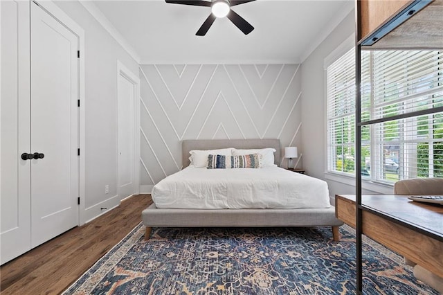 313 Sisson Ave NE, Atlanta, GA 30317 - bedroom with wood finished floors, crown molding, a decorative wall, and a ceiling fan