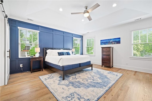 313 Sisson Ave NE, Atlanta, GA 30317 - bedroom featuring light wood-type flooring, a tray ceiling, a ceiling fan, recessed lighting, and baseboards
