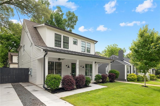 313 Sisson Ave NE, Atlanta, GA 30317 - view of front facade featuring a standing seam roof, a porch, board and batten siding, ceiling fan, and metal roof