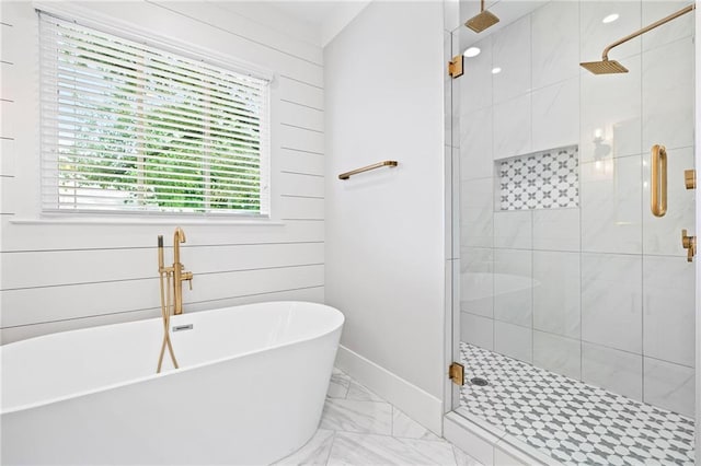 313 Sisson Ave NE, Atlanta, GA 30317 - bathroom featuring a freestanding tub, a stall shower, marble look tiles, and baseboards