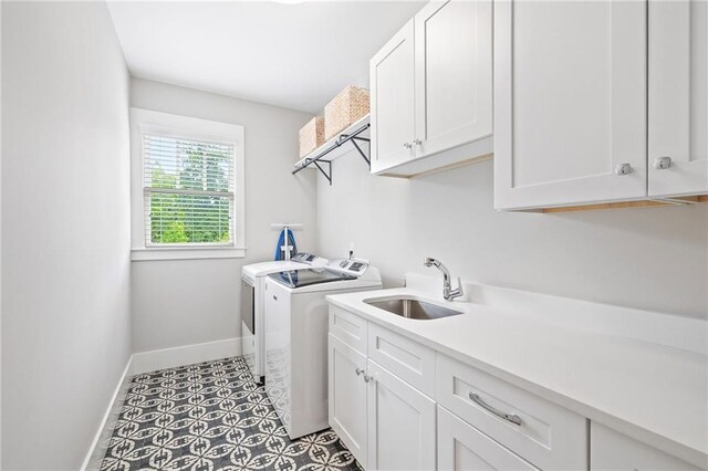 313 Sisson Ave NE, Atlanta, GA 30317 - laundry room with cabinet space, separate washer and dryer, and baseboards