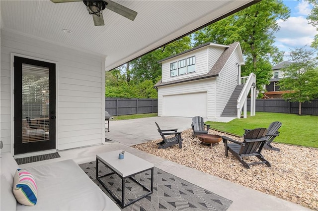 313 Sisson Ave NE, Atlanta, GA 30317 - view of patio / terrace with stairway, a garage, a fire pit, driveway, and ceiling fan