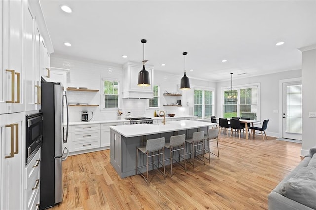 313 Sisson Ave NE, Atlanta, GA 30317 - kitchen featuring open shelves, freestanding refrigerator, a breakfast bar area, backsplash, and light countertops