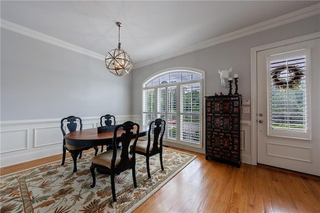 359 Alderwood Ln, Atlanta, GA 30328 - dining area featuring crown molding, a chandelier, light wood finished floors, and wainscoting