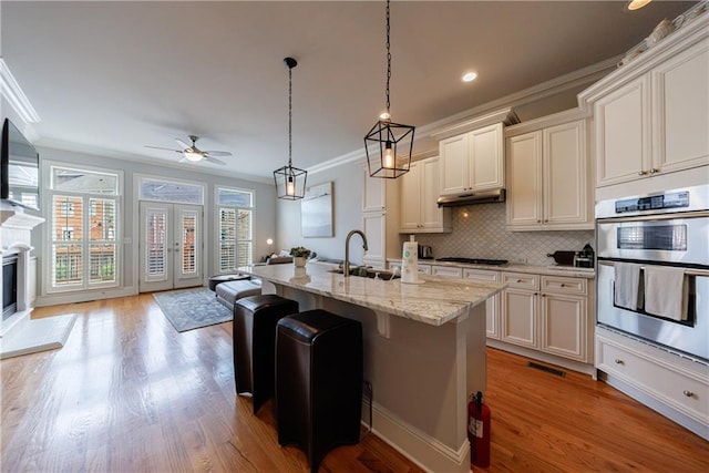 359 Alderwood Ln, Atlanta, GA 30328 - kitchen with a sink, double oven, ornamental molding, open floor plan, and gas cooktop