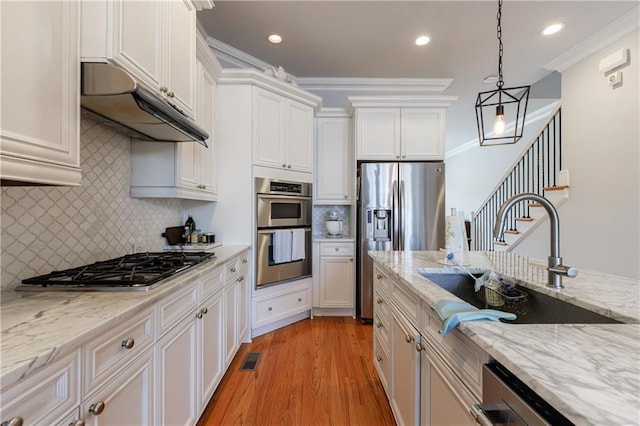 359 Alderwood Ln, Atlanta, GA 30328 - kitchen featuring stainless steel appliances, a sink, under cabinet range hood, white cabinets, and light wood-style floors