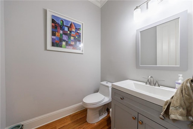 359 Alderwood Ln, Atlanta, GA 30328 - half bathroom with wood finished floors, toilet, vanity, baseboards, and crown molding