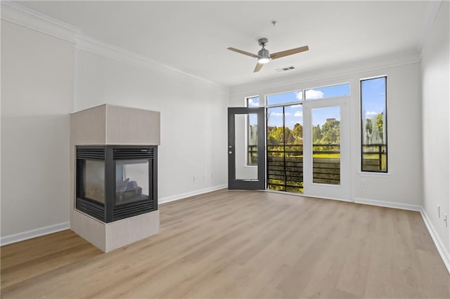 401 16th St NW Unit 1357, Atlanta, GA 30363 - unfurnished living room with light wood-style flooring, crown molding, ceiling fan, and a multi sided fireplace