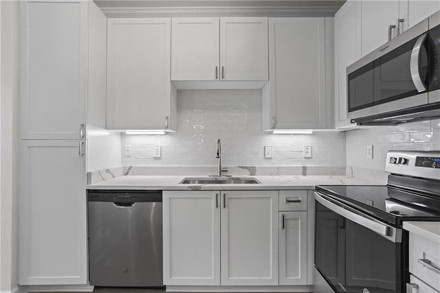 401 16th St NW Unit 1357, Atlanta, GA 30363 - kitchen featuring stainless steel appliances, tasteful backsplash, and white cabinetry