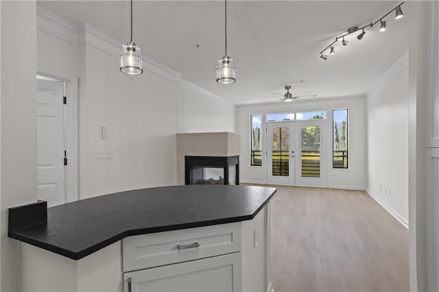 401 16th St NW Unit 1357, Atlanta, GA 30363 - kitchen with dark countertops, ornamental molding, a multi sided fireplace, open floor plan, and light wood-style flooring
