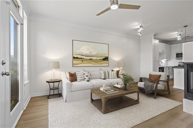 401 16th St NW Unit 1357, Atlanta, GA 30363 - living room featuring ornamental molding, light wood-style flooring, and ceiling fan