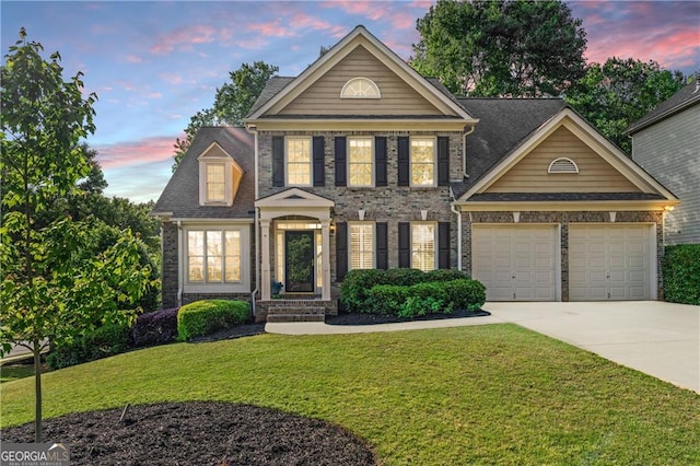 view of front of property with a lawn, a garage, driveway, and brick siding