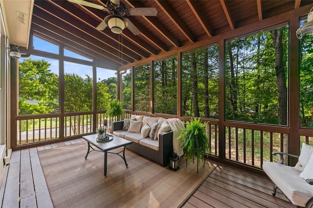 sunroom with ceiling fan, visible vents, beam ceiling, and an outdoor hangout area