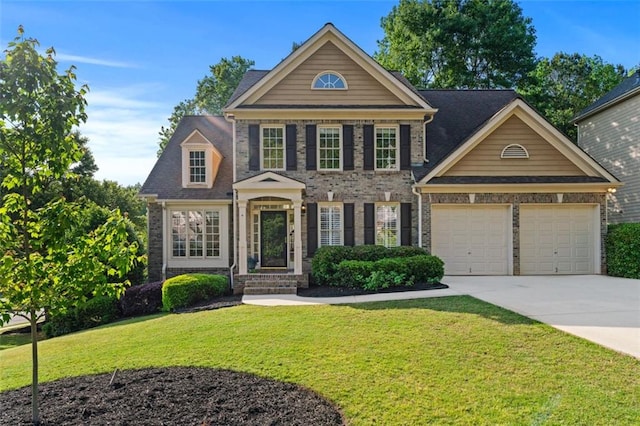 view of front of property featuring an attached garage, concrete driveway, a front yard, and brick siding
