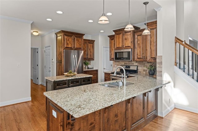 kitchen with appliances with stainless steel finishes, tasteful backsplash, baseboards, a peninsula, and light wood-style floors