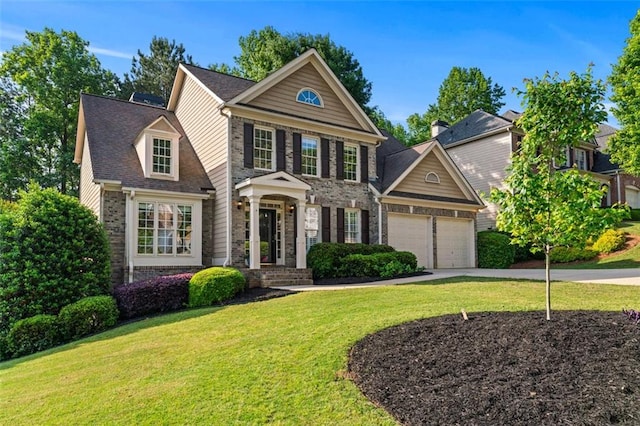 view of front of home with an attached garage, driveway, brick siding, and a front yard