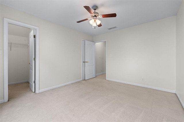 unfurnished bedroom with visible vents, baseboards, and light carpet