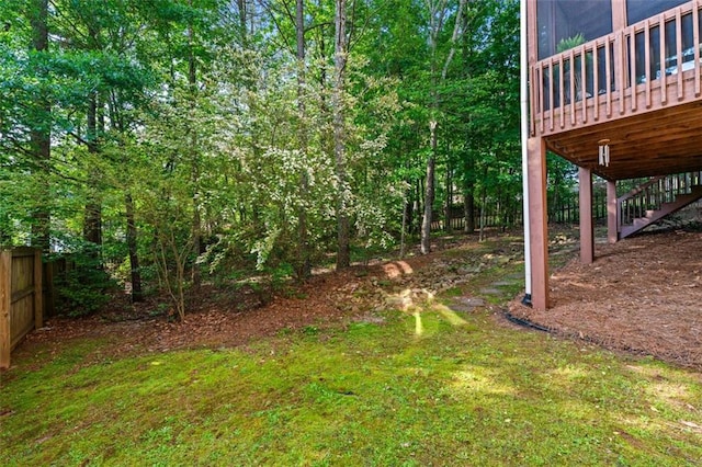 view of yard with stairs, fence, and a deck