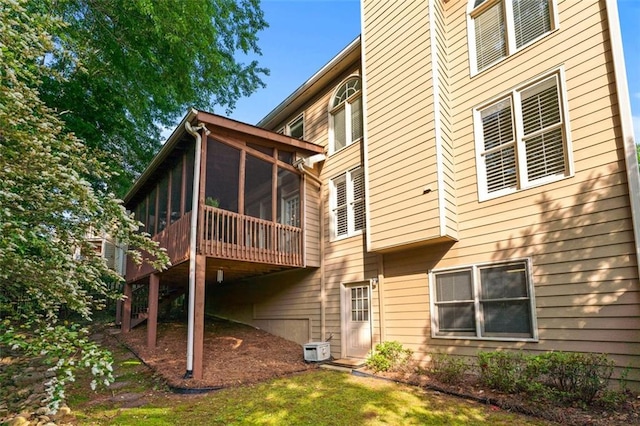 rear view of house featuring a sunroom