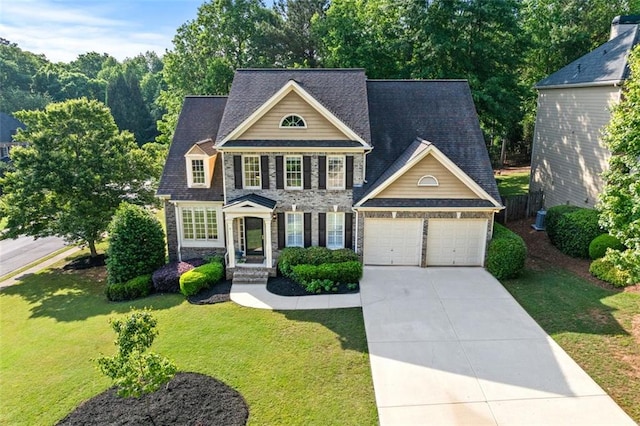 view of front of property featuring driveway, a front lawn, stone siding, and a garage