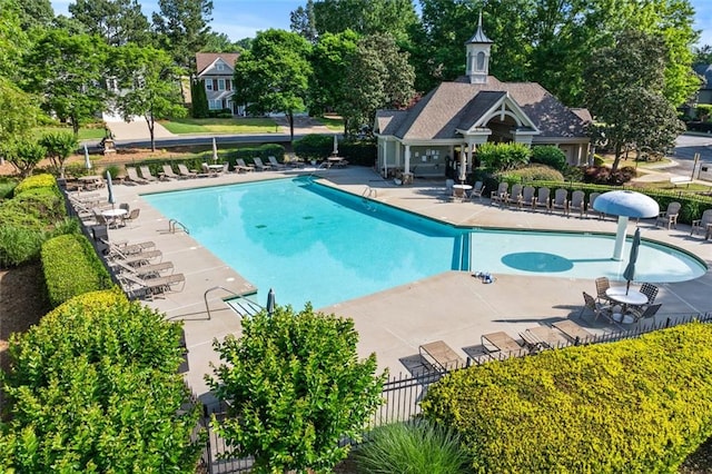 pool featuring a patio and fence